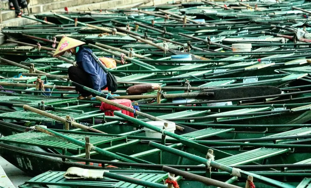 Local sit on a boat in Tam Coc Wharf