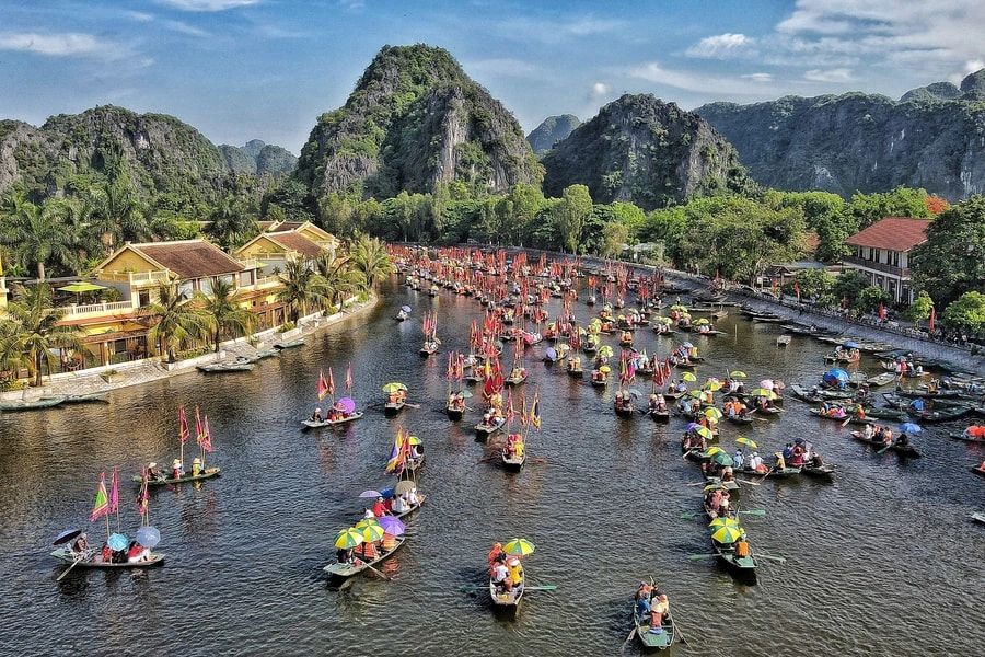 People sailing sampan boat in Ninh Binh historical festival