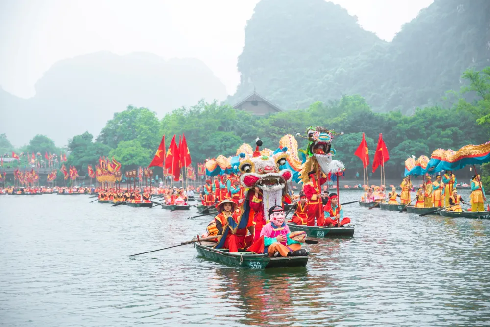 Procession sailing along Sao Khe river during Trang An festival