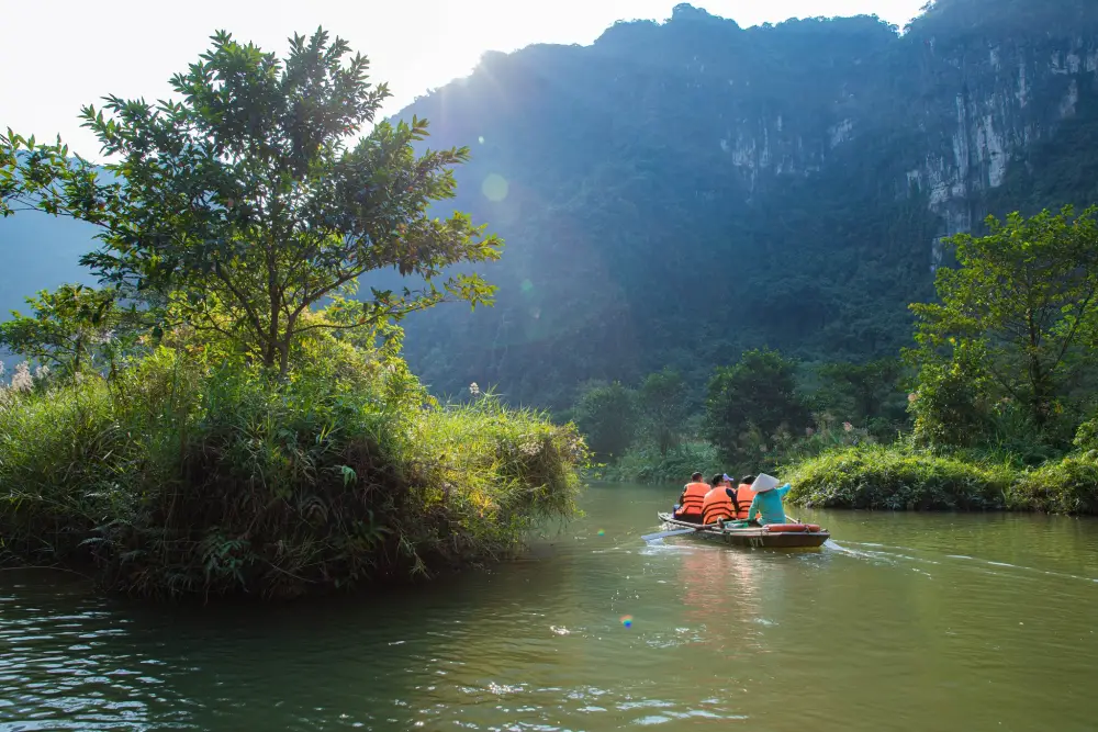 Sailing boat along Van Long Wetland Nature Reserve