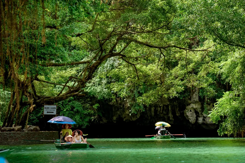 Riding boat into the cave of Tam Coc, Ninh Binh