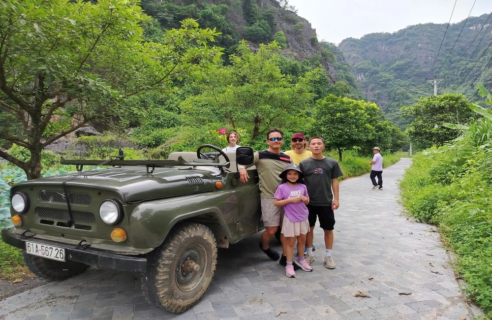 Tourists next to a Jeep car